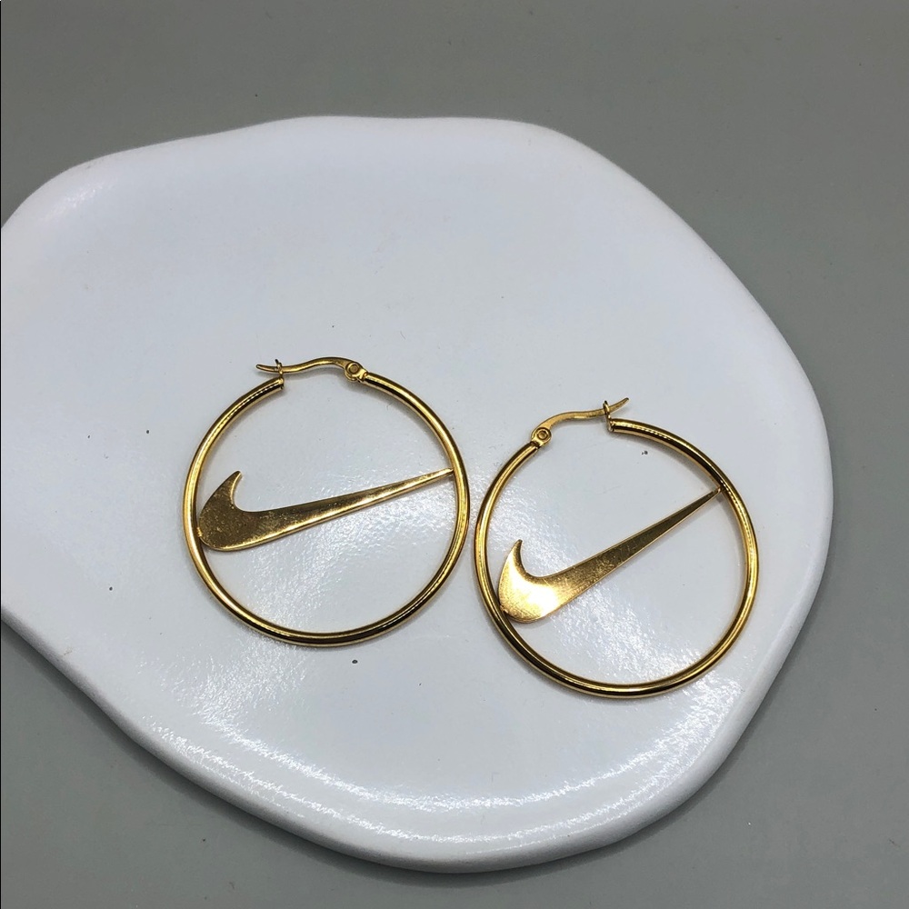 Nike swoosh logo gold tone hoop earrings statement style.